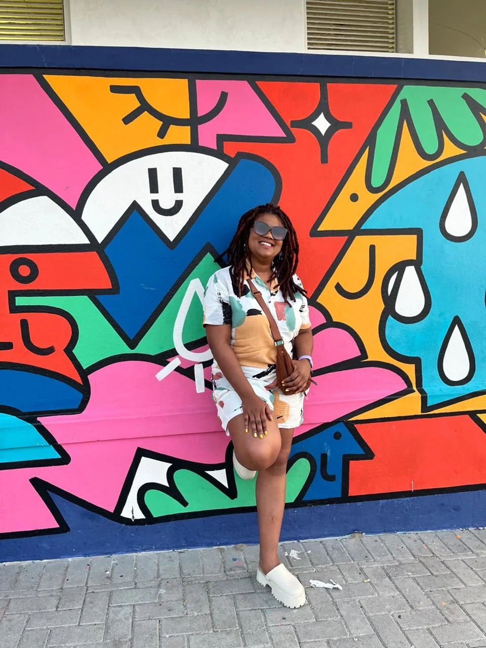 Janine Fortuin in front of a colourful Cape Town mural
